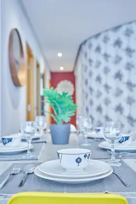 a table with plates and glasses on a table at Chic 3BR in Racine by Bd Massira in Casablanca