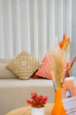 two pillows sitting on a couch with a table at Soleya Apartment with Pool near Mohammed V Airport in Nouaseur