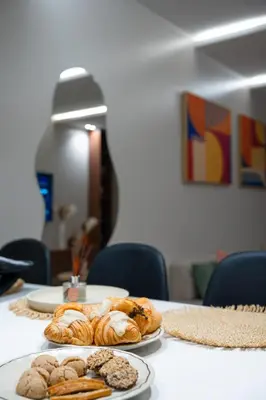 a table with three plates of pastries on it at Soleya Apartment with Pool near Mohammed V Airport in Nouaseur