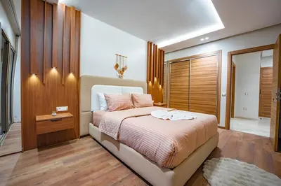 a bedroom with a large bed with pink pillows at Soleya Apartment with Pool near Mohammed V Airport in Nouaseur