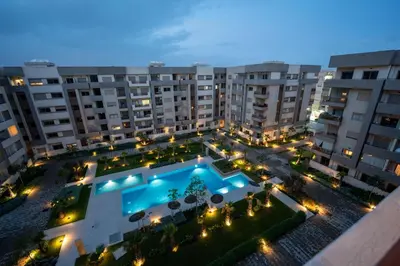 an overhead view of a courtyard with a swimming pool at Soleya Apartment with Pool near Mohammed V Airport in Nouaseur