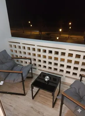 a living room with two chairs and a table at Appartement vue sur mer - Chill ocean view in Rabat