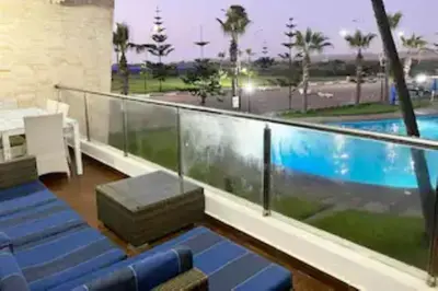 a balcony with a swimming pool in a building at Casablanca !Tamaris! 2 bedrooms! Pool & Sea View! in Dar Sidi Slimane