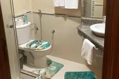a bathroom with a toilet and a sink at Casablanca !Tamaris! 2 bedrooms! Pool & Sea View! in Dar Sidi Slimane
