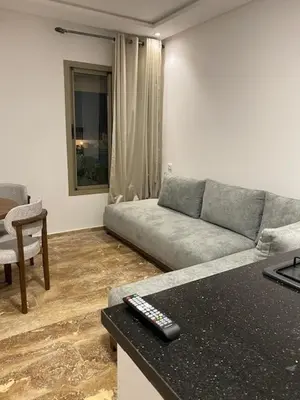 a living room with a couch and a table at heaven beach in Sidi Rahal