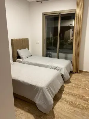 a room with two beds and a window at heaven beach in Sidi Rahal
