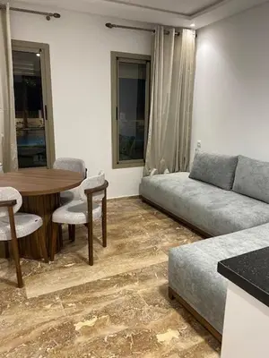 a living room with a couch and a table at heaven beach in Sidi Rahal