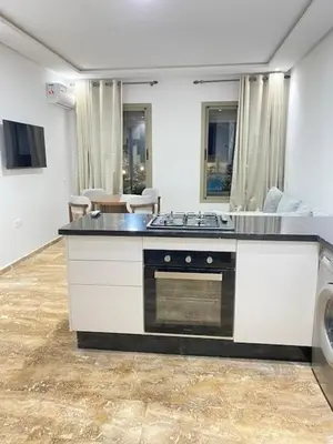 a kitchen with a stove top oven in a room at heaven beach in Sidi Rahal