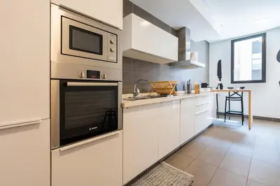 a kitchen with white cabinets and a microwave at Luxury Apartment Anfaplace Cosy & Design in Casablanca