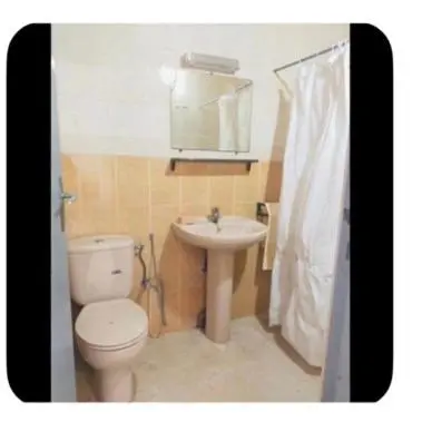 a bathroom with a toilet and a sink at Dar Khnata in Temara