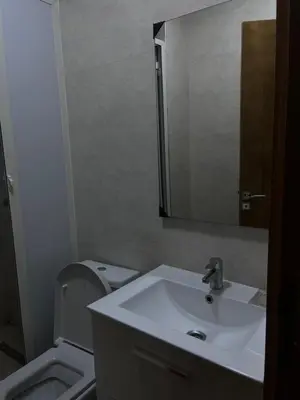 a bathroom with a sink and a toilet and a mirror at Havre de paix in Rabat