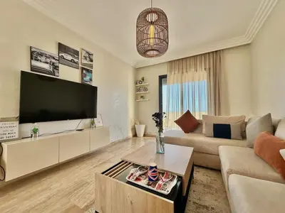 a living room with a large flat screen tv at 2BR Sea View Apartment - Balcony I Parking in Rabat