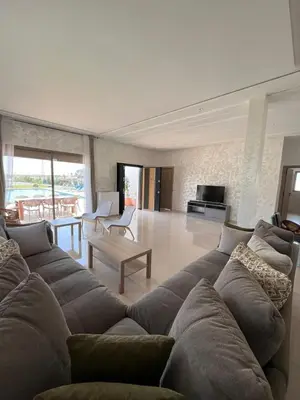 a living room with a couch and a table at Riad El menez in Bouznika