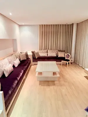 a living room with a couch and a table at Prestigia Golf City Bouskoura in Bouskoura
