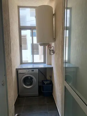 a laundry room with a washing machine and a window at Cozy apt in Bourgogne - Ain Diab Coast in Casablanca