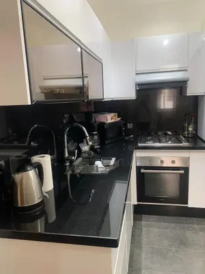 a kitchen with a sink and a stove at Cozy apt in Bourgogne - Ain Diab Coast in Casablanca