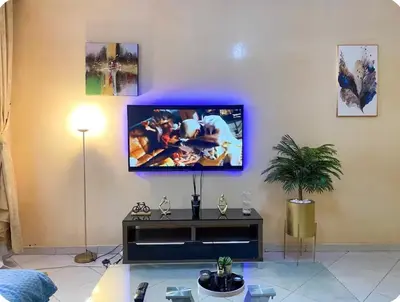 a living room with a tv on the wall at Appartement Clémentine C in Les Camps