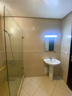 a bathroom with a sink and a glass shower at Appartement Clémentine C in Les Camps