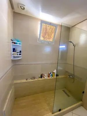 a bathroom with a shower with a glass shower stall at Appartement Clémentine C in Les Camps