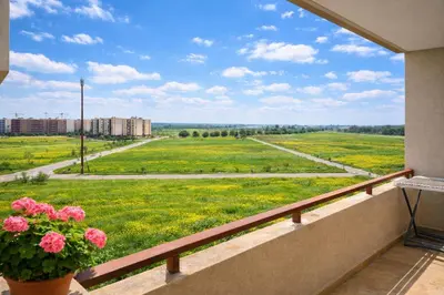 a balcony with a view of a field of flowers at Modern Cozy Apartment in Prime Location in Nouaceur