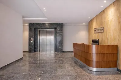 an office lobby with a reception desk and a elevator at Modern Cozy Apartment in Prime Location in Nouaceur