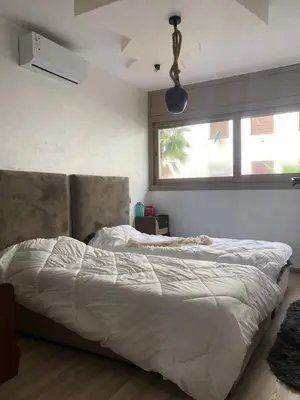 a bedroom with a bed and a window at Chez Abir in Rabat