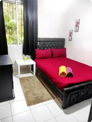 a black bed with red sheets in a room at Cosy appart 1min de casanearshore & Zinit in Casablanca
