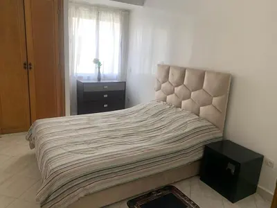a bedroom with a large bed with a window at Beach Ain Diab - Beautiful Apt in Bourgogne in Casablanca