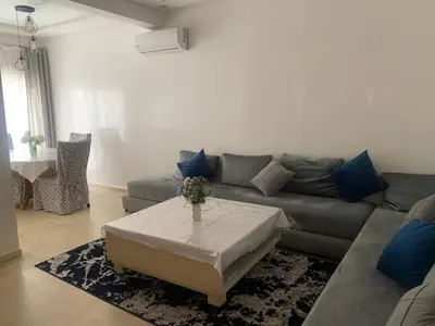a living room with a couch and a table at Beach Ain Diab - Beautiful Apt in Bourgogne in Casablanca