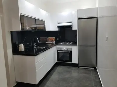 a kitchen with a sink and a refrigerator at Beach Ain Diab - Beautiful Apt in Bourgogne in Casablanca