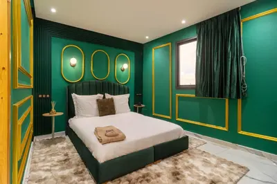 a bedroom with a large bed with green walls at Casablanca Luxury Penthouse with Jacuzzi & Views in Casablanca