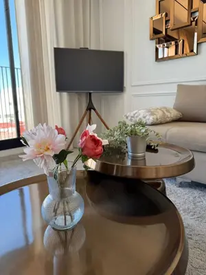 a living room with a vase of flowers on a table at Havre moderne et lumineux calme avec parking in Casablanca