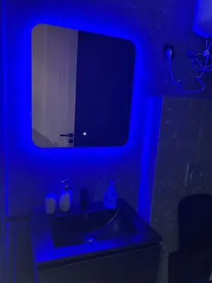 a bathroom with a sink with a blue light at Havre moderne et lumineux calme avec parking in Casablanca
