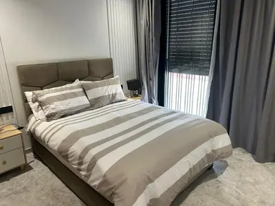a bedroom with a large bed and a window at Havre moderne et lumineux calme avec parking in Casablanca