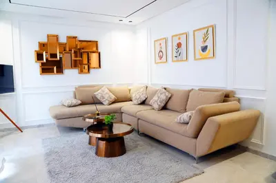 a living room with a couch and a table at Havre moderne et lumineux calme avec parking in Casablanca