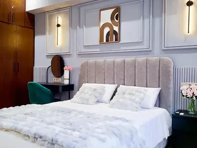 a bedroom with a large bed with white sheets and pillows at Prestige appartement centre Agdal Rabat in Rabat