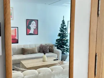 a living room with a white couch and a christmas tree at Chic central Stay in Agdal in Rabat