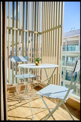 a table and two chairs on a balcony at Cosy studio disponible sur maarif princesses in Casablanca