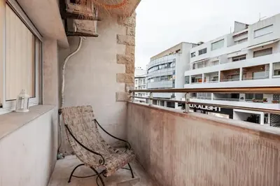a chair sitting on the balcony of a building at Moderne, 2 CH, Fibre optique, AC Garage Ascenseur in Rabat