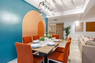 a dining room with a table and chairs and a couch at Moderne, 2 CH, Fibre optique, AC Garage Ascenseur in Rabat