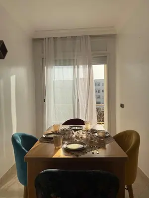 a dining room table with decorations on it with a window at Charming 1 bedroom apartment Ocean living room, Rabat in Rabat