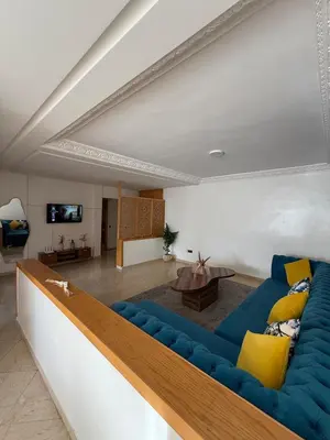 a living room with a blue couch and a table at Charming 1 bedroom apartment Ocean living room, Rabat in Rabat