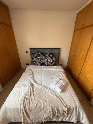 a bedroom with a large bed with a blanket on it at Charming 1 bedroom apartment Ocean living room, Rabat in Rabat