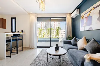 a living room with a couch and a table at Centrale studio with Nice terasse in Maarif