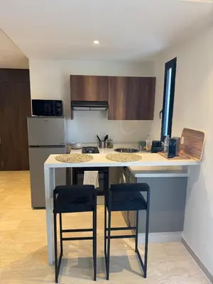 a kitchen with a counter with two chairs and a table at Centrale studio with Nice terasse in Maarif