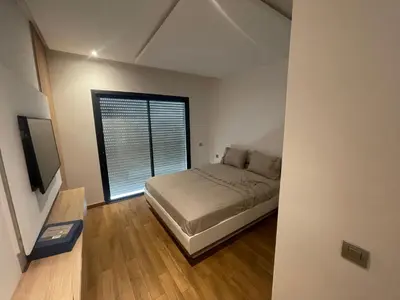 a small bedroom with a bed and a window at Prestigia appartement in Rabat