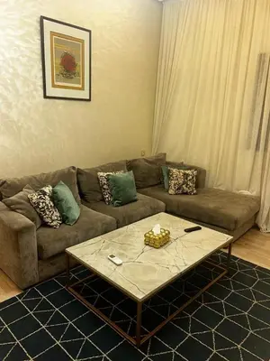 a living room with a couch and a coffee table at Cozy Apt Near Train Station in Rabat