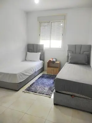 a bedroom with two beds and a window at appart a 5min de l'hôpital Mohamed 6 in Casablanca
