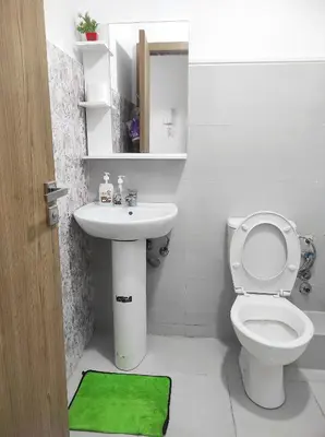 a bathroom with a white toilet and a sink at appart a 5min de l'hôpital Mohamed 6 in Casablanca