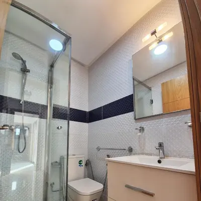a bathroom with a shower and a toilet and a sink at Appartement familial au quartier des Hôpitaux in Casablanca